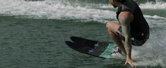 Recreational skier riding Radar X-Caliber combo water skis behind a boat