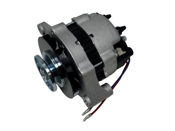 A used silver and black alternator with a blue metallic pulley and attached red and blue wires, photographed on a light gray surface.