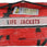 Kent Type II adult life jacket 4-pack with orange USCG approved PFDs and storage bag
