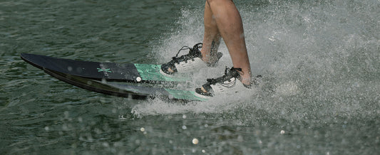 Recreational skier riding Radar X-Caliber combo water skis behind a boat