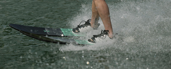 Recreational skier riding Radar X-Caliber combo water skis behind a boat