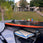 Ronix four-board wakesurf carrier mounted to a boat Bimini top