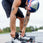 action shot of person putting on the Ronix Kinetik wakeboard boots