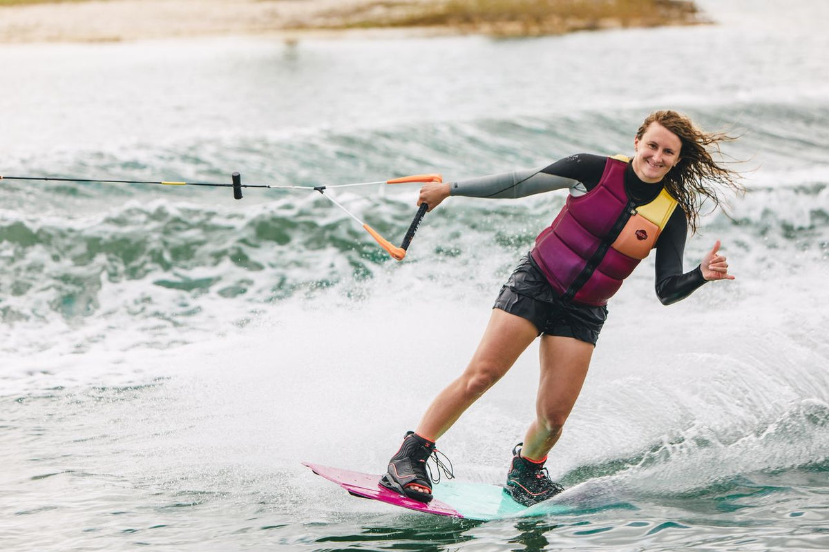 Female rider wakeboarding behind a boat on the Ronix Krush