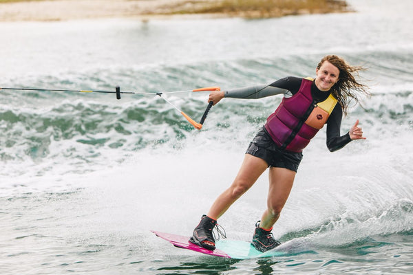 Female rider wakeboarding behind a boat on the Ronix Krush