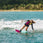 Female rider wakeboarding behind a boat on the Ronix Krush