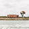 Female rider wakeboarding behind a boat on the Ronix Krush