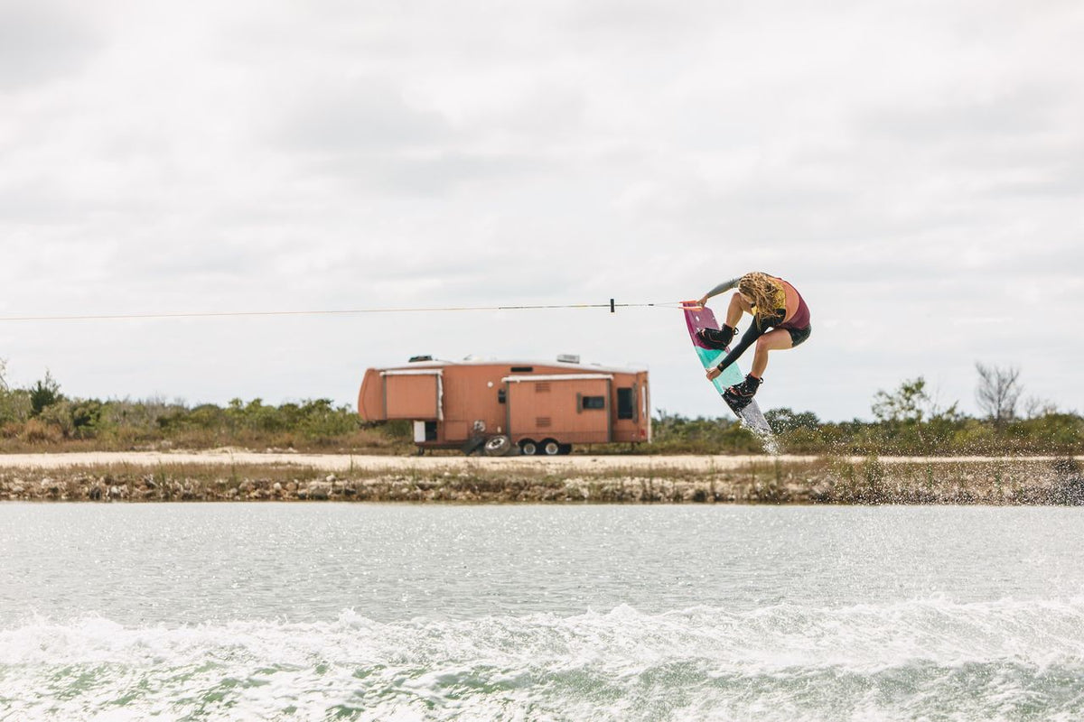 Female rider wakeboarding behind a boat on the Ronix Krush