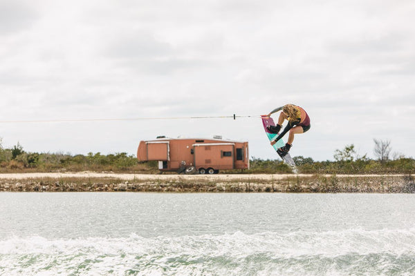 Female rider wakeboarding behind a boat on the Ronix Krush