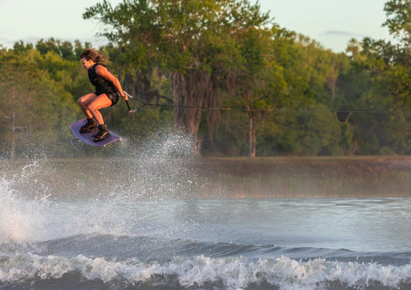 action shot of woman on a ronix wakeboard with the Ronix Luxe wakeboard boots