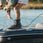 person on a boat wearing 2026 Ronix One Gloss Midnight Intuition closed-toe wakeboard boots